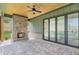 Outdoor patio with a brick fireplace, wood ceiling, and fan at 504 Barrington Drive, Roswell, GA 30075