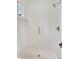 Modern tiled shower with glass door, a shower head, a built-in niche, and a tiled shower floor at 504 Barrington Drive, Roswell, GA 30075
