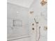 Close up of shower showcasing marble tile and brushed gold fixtures at 504 Barrington Drive, Roswell, GA 30075