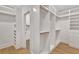 Bright walk-in closet with custom shelves and hanging rods at 504 Barrington Drive, Roswell, GA 30075