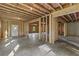 Unfinished basement with framed walls, concrete floors, and potential for future living space at 6132 Hutchins Dr, Buford, GA 30518