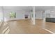 Spacious living area with fireplace, hardwood floors, and access to the outdoor patio at 6132 Hutchins Dr, Buford, GA 30518