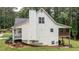 Back exterior of a home with a chimney, back deck, and view of wooded surroundings at 10 Stagg Trce, Social Circle, GA 30025