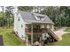 Exterior of a home featuring a covered back deck, stairs, and a peaceful view of the surrounding greenery at 10 Stagg Trce, Social Circle, GA 30025