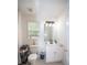 Bright bathroom featuring a toilet, vanity with storage, a large mirror, and natural light from a window at 10 Stagg Trce, Social Circle, GA 30025