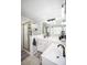 Bright bathroom with a glass-enclosed shower and double vanity with modern light fixtures and a neutral color palette at 10 Stagg Trce, Social Circle, GA 30025