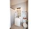 A clean bathroom with white cabinets, a gray shower curtain, and a mirror with lighting at 10 Stagg Trce, Social Circle, GA 30025