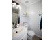A clean and bright bathroom with a vanity, modern faucet, and stylish wall decor and shelf at 10 Stagg Trce, Social Circle, GA 30025