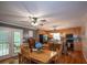Open-concept dining area that flows to the kitchen with stainless steel appliances and hardwood floors at 10 Stagg Trce, Social Circle, GA 30025