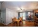 A dining room featuring hardwood floors, neutral paint colors, a ceiling fan, and an adjacent door to outside at 10 Stagg Trce, Social Circle, GA 30025
