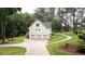 The rear of the house has a three-car garage and a stairway to an expansive elevated deck and beautiful yard at 10 Stagg Trce, Social Circle, GA 30025