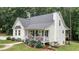 Well-maintained two-story home with a front porch, manicured lawn, and blossoming hydrangea bushes at 10 Stagg Trce, Social Circle, GA 30025