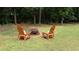 Backyard features a fire pit with two Adirondack chairs, creating a cozy spot for outdoor gatherings at 10 Stagg Trce, Social Circle, GA 30025