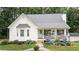 Charming one-story home featuring a welcoming porch, manicured lawn, and blooming hydrangea bushes at 10 Stagg Trce, Social Circle, GA 30025