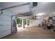 Spacious garage with open door, featuring ample workspace and storage for vehicles and projects at 10 Stagg Trce, Social Circle, GA 30025