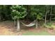 Relaxing hammock strung between mature trees in a private backyard, perfect for enjoying peaceful afternoons at 10 Stagg Trce, Social Circle, GA 30025