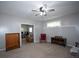 Spacious living room with a cozy carpet, neutral paint, ceiling fan and views to the other room at 10 Stagg Trce, Social Circle, GA 30025