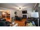 Open living room features hardwood floors, fireplace, and view into the dining area at 10 Stagg Trce, Social Circle, GA 30025