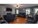 Comfortable living room with hardwood floors, a fireplace, and natural light from windows at 10 Stagg Trce, Social Circle, GA 30025