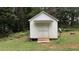 Exterior of a storage shed in a green, wooded backyard at 10 Stagg Trce, Social Circle, GA 30025