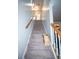 Carpeted stairway with a wooden railing leading upstairs with natural light at 10 Stagg Trce, Social Circle, GA 30025