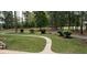 Expansive yard showcases beautiful landscaping and mature trees, enhancing the property's curb appeal and outdoor enjoyment at 10 Stagg Trce, Social Circle, GA 30025