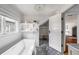 Bright bathroom featuring a modern tub, stylish shelving, and hexagonal tile flooring, offering a blend of comfort and style at 1038 Saint Charles Ave, Atlanta, GA 30306