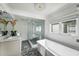 Modern bathroom features a luxurious soaking tub, glass-enclosed shower, and double vanity, creating a spa-like experience at 1038 Saint Charles Ave, Atlanta, GA 30306