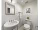 Classic bathroom with white subway tiles, pedestal sink, and stylish mirror above at 1038 Saint Charles Ave, Atlanta, GA 30306