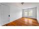 This bedroom features hardwood floors, a light, and a six-panel door at 1038 Saint Charles Ave, Atlanta, GA 30306