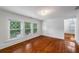 Bright bedroom with hardwood floors, white trim, and large windows with cross-hatched blinds at 1038 Saint Charles Ave, Atlanta, GA 30306