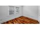 Cozy bedroom featuring hardwood floors, crisp white trim, and windows with classic blinds at 1038 Saint Charles Ave, Atlanta, GA 30306