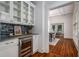 Charming butler's pantry features mosaic tile backsplash, beverage cooler, and wood floors at 1038 Saint Charles Ave, Atlanta, GA 30306