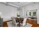 Bright dining room boasts hardwood floors, modern chandelier, and view of the living room at 1038 Saint Charles Ave, Atlanta, GA 30306