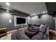 Entertainment room featuring large sectional sofa, hardwood floors and large screen TV at 1038 Saint Charles Ave, Atlanta, GA 30306