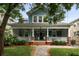 Charming two-story home featuring a spacious front porch, lush landscaping, and classic architectural details at 1038 Saint Charles Ave, Atlanta, GA 30306