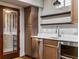Wet bar with stainless steel dishwasher and wine cooler, plus wooden cabinets at 1038 Saint Charles Ave, Atlanta, GA 30306