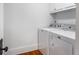 Functional laundry area with washer and dryer units, and upper cabinet storage at 1038 Saint Charles Ave, Atlanta, GA 30306