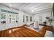 Spacious living room with hardwood floors, large windows, and a fireplace at 1038 Saint Charles Ave, Atlanta, GA 30306