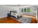 Large bedroom with hardwood floors and plenty of natural light, making it an ideal space for relaxation and comfort at 1038 Saint Charles Ave, Atlanta, GA 30306