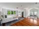 Spacious bedroom featuring hardwood floors, many windows and natural light, complemented by stylish furnishings at 1038 Saint Charles Ave, Atlanta, GA 30306
