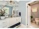 Modern bathroom featuring elegant vanity with marble countertop and decorative tile accent wall at 111 Cherry Hill Dr, Marietta, GA 30067