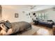 This bedroom with hardwood floors is furnished with a blue sofa, desk area, and ample natural light at 111 Cherry Hill Dr, Marietta, GA 30067