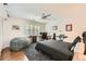 A bedroom boasting a gray color palette, a ceiling fan, hardwood floors and natural light from the shuttered window at 111 Cherry Hill Dr, Marietta, GA 30067