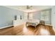 A sunlit bedroom featuring hardwood floors, a ceiling fan and stylish decor and a light blue color palette at 111 Cherry Hill Dr, Marietta, GA 30067