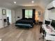Bedroom features hardwood floors, king bed, sitting area and desk at 111 Cherry Hill Dr, Marietta, GA 30067