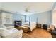 Comfortable bedroom offering natural light, ceiling fan and cozy seating, perfect for relaxation at 111 Cherry Hill Dr, Marietta, GA 30067
