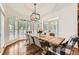 Cozy dining area with a rustic wood table, bay windows, and natural lighting at 111 Cherry Hill Dr, Marietta, GA 30067