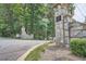 Community entrance with stone pillars, mature trees, and well-maintained landscaping at 111 Cherry Hill Dr, Marietta, GA 30067