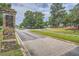 Stone entrance to a private country club community with lush landscaping and signage at 111 Cherry Hill Dr, Marietta, GA 30067